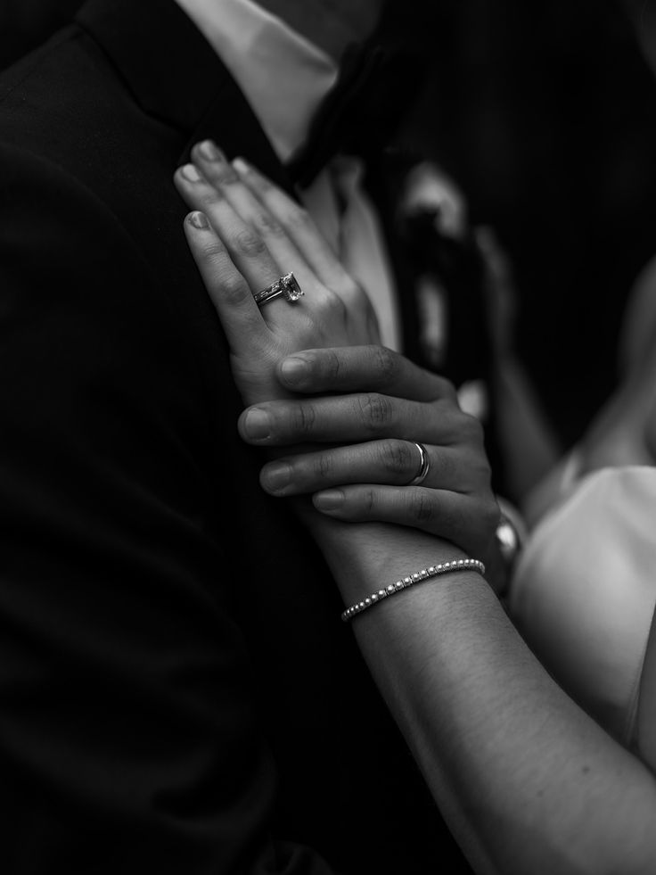 Hands with wedding rings resting over the heart